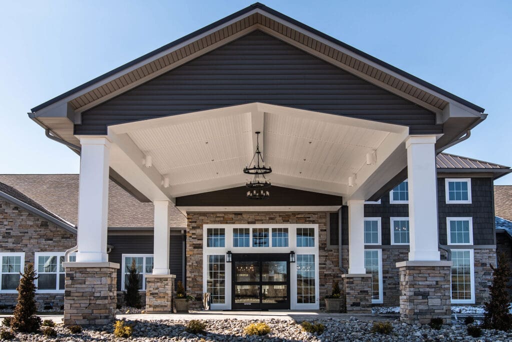 Front entrance of Charter Senior Living of White House featuring stone and wood design in Tennessee.