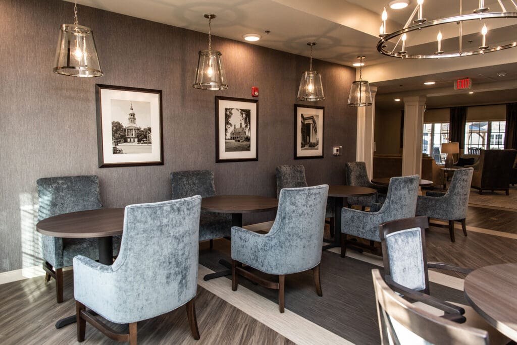 Elegant indoor seating area with framed photos and soft lighting at Charter Senior Living of White House.